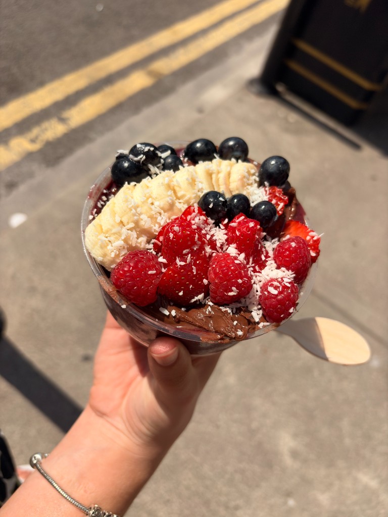 Açaí bowl topped with banana, berries and coconut